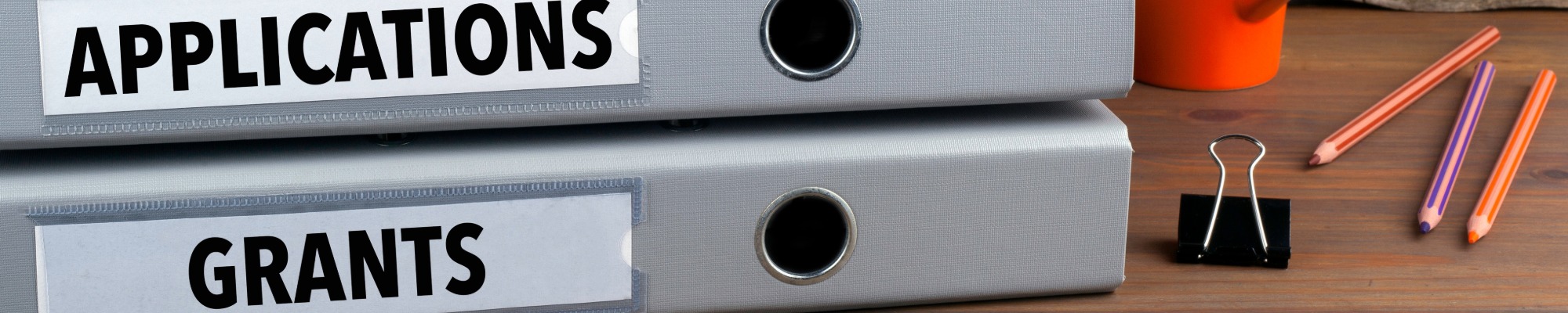binders labeled with applications and grants